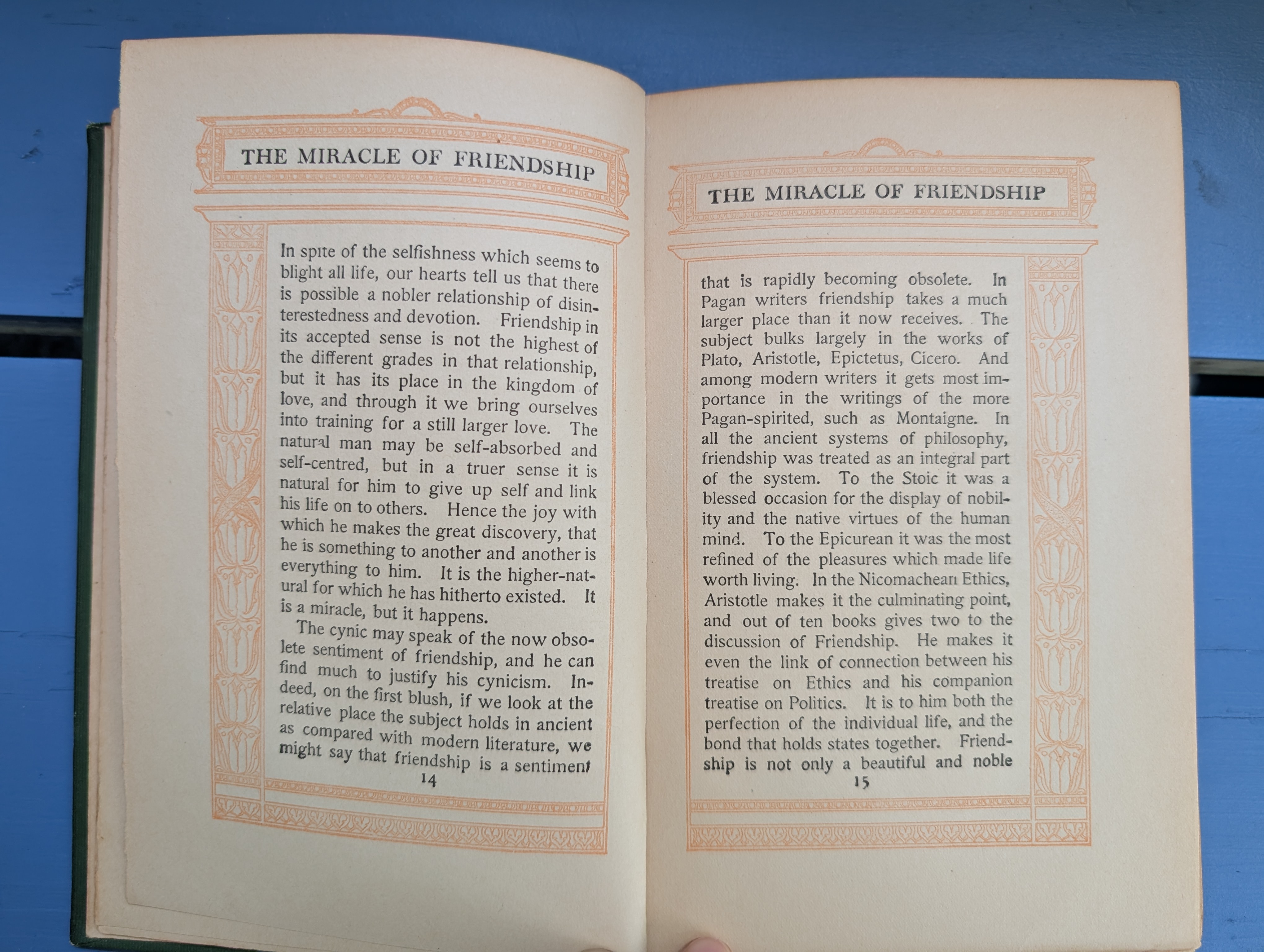 Two pages within Friendship by Hugh Black with the text block surrounded by an ornate orange border